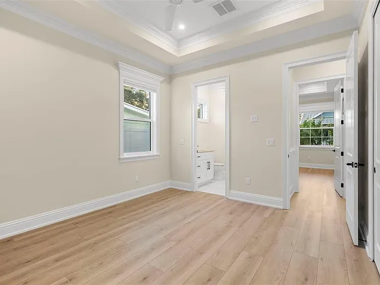 LVP bedroom with ensuite tray ceiling Holiday FL