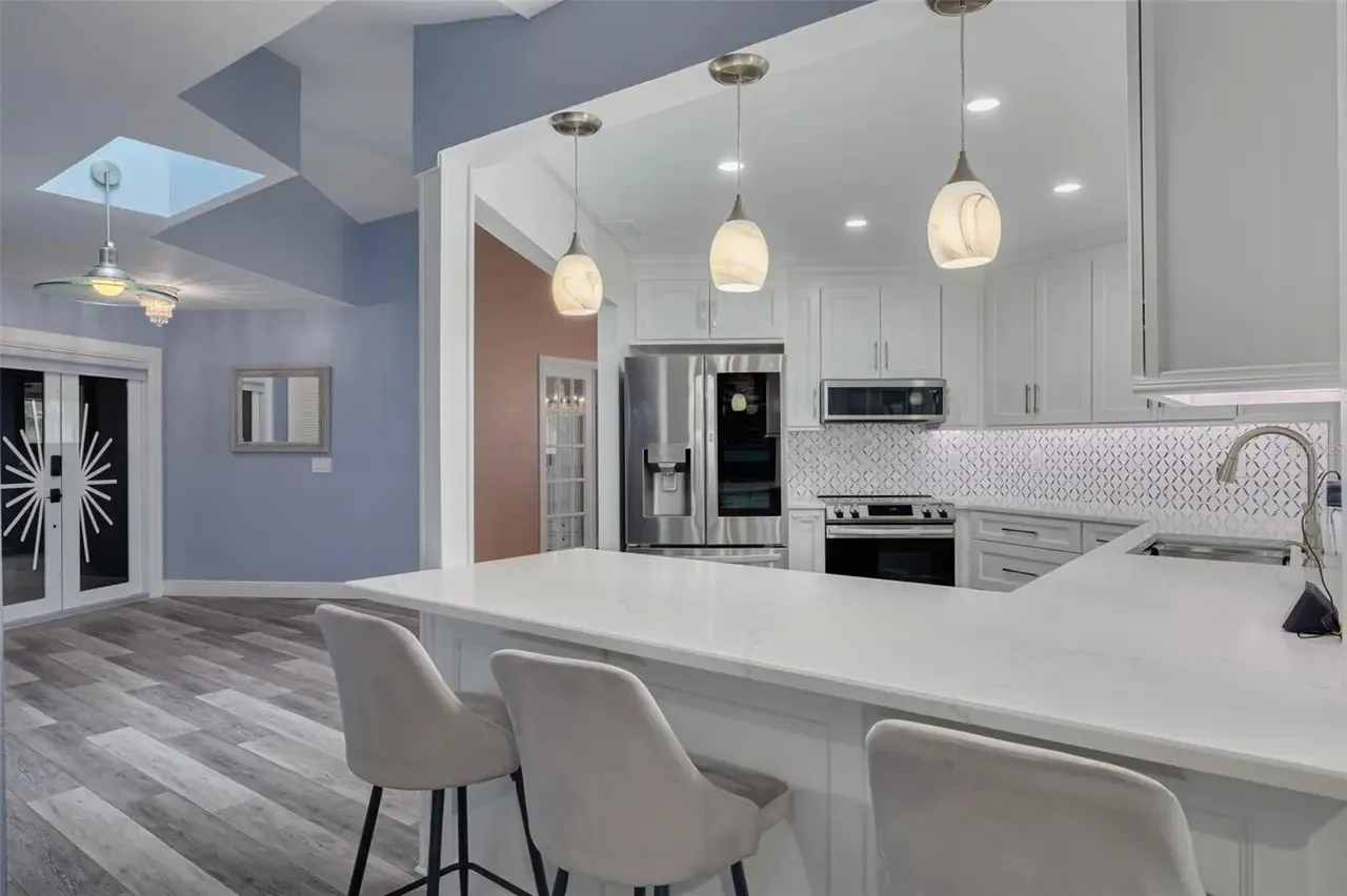 LVP kitchen bar seating skylight Holiday FL