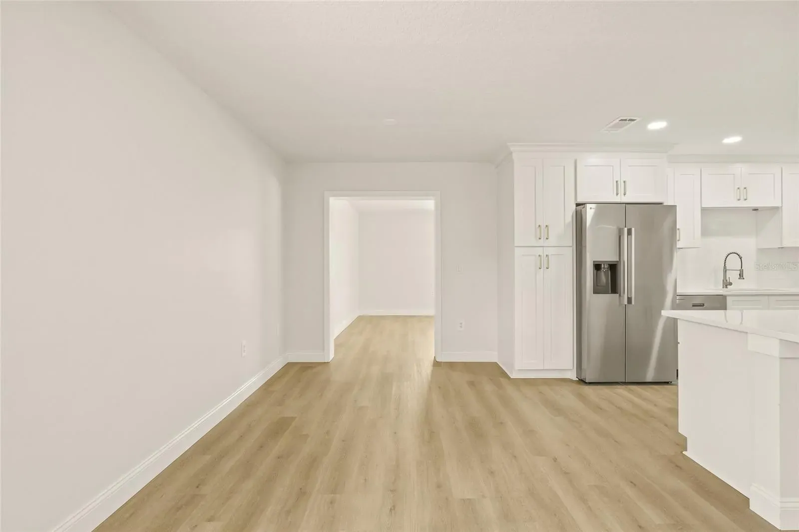 LVP kitchen stainless appliances open plan Holiday FL