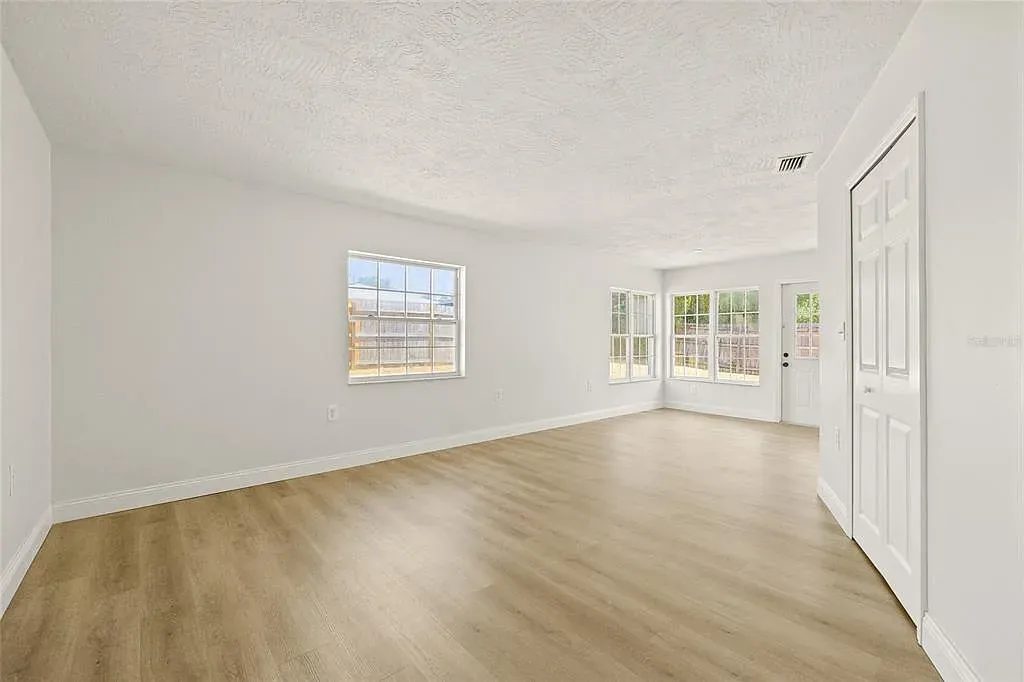 LVP living room open plan vaulted beams Holiday FL