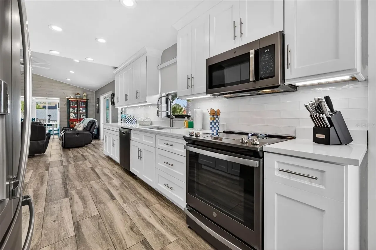 Wood-look tile kitchen white cabinets Holiday FL